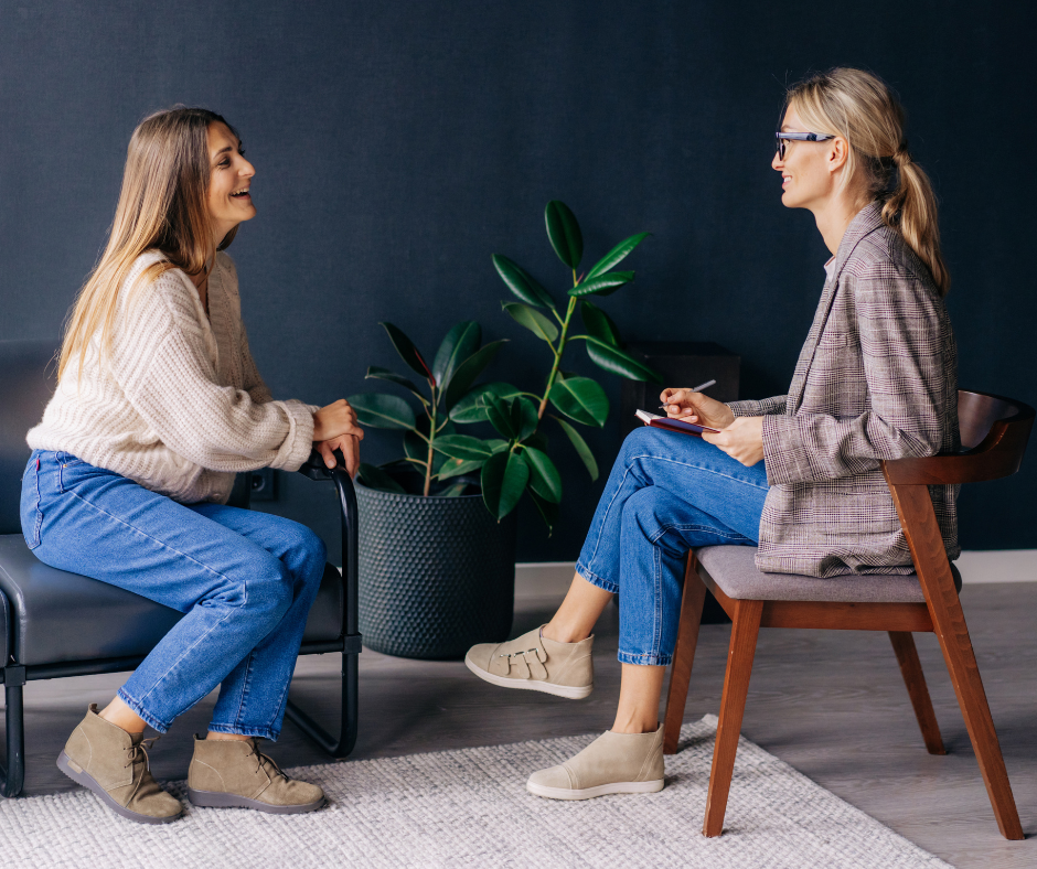Two women talking in a coaching session. The purpose of this blog is to show you how to have simple coaching conversations that drive high performance. 
